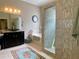 Bathroom featuring a shower with decorative tile, soaking tub and granite countertops on the vanity at 9602 Coastal Pointe Dr, Villa Rica, GA 30180