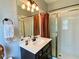 Updated bathroom featuring sleek vanity, modern fixtures, and a shower with glass door at 9602 Coastal Pointe Dr, Villa Rica, GA 30180