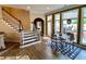 Dining area features hardwood floors, staircase, and windows overlooking the outside patio area at 9602 Coastal Pointe Dr, Villa Rica, GA 30180