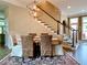 Dining room showcasing modern lighting and staircase in a neutrally decorated home at 9602 Coastal Pointe Dr, Villa Rica, GA 30180