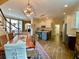 Open dining room flows into kitchen with island, and neutral color palettes at 9602 Coastal Pointe Dr, Villa Rica, GA 30180