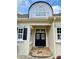 Elegant entryway featuring double doors with decorative glass, a stone landing, and a transom window above at 9602 Coastal Pointe Dr, Villa Rica, GA 30180