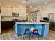 Stylish kitchen boasts a granite island with bar stools, modern appliances, and white and dark wood cabinetry at 9602 Coastal Pointe Dr, Villa Rica, GA 30180