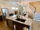 Spacious kitchen island with granite countertop, stainless steel dishwasher, and dark sink at 9602 Coastal Pointe Dr, Villa Rica, GA 30180