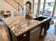 Close up of spacious kitchen island with granite countertop and stainless steel dishwasher at 9602 Coastal Pointe Dr, Villa Rica, GA 30180
