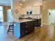 Bright kitchen with hardwood floors, granite counters, stainless appliances and a blue accent island at 9602 Coastal Pointe Dr, Villa Rica, GA 30180