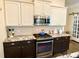 Updated kitchen featuring stainless appliances, light cabinets and backsplash at 9602 Coastal Pointe Dr, Villa Rica, GA 30180
