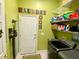Functional laundry room with a washer and dryer, shelving for storage, and tile flooring for easy cleaning at 9602 Coastal Pointe Dr, Villa Rica, GA 30180