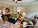 Spacious living room with hardwood floors, piano, and comfortable furnishings at 9602 Coastal Pointe Dr, Villa Rica, GA 30180
