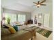 Bright main bedroom featuring a ceiling fan, carpet flooring, and a large window with wooden shutters at 9602 Coastal Pointe Dr, Villa Rica, GA 30180
