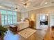 Inviting primary bedroom suite with hardwood floors, tray ceiling, and natural light at 9602 Coastal Pointe Dr, Villa Rica, GA 30180