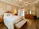 Spacious main bedroom features a tray ceiling, hardwood floors, and a decorative accent wall at 9602 Coastal Pointe Dr, Villa Rica, GA 30180