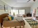 Bright main bedroom featuring a ceiling fan, carpet flooring, and a large window with wooden shutters at 9602 Coastal Pointe Dr, Villa Rica, GA 30180