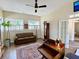 Cozy office featuring a ceiling fan, hardwood floors, neutral paint colors, and large windows for plenty of natural light at 9602 Coastal Pointe Dr, Villa Rica, GA 30180