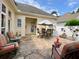 Spacious stone patio with outdoor dining and lounge areas, perfect for entertaining or relaxing outdoors at 9602 Coastal Pointe Dr, Villa Rica, GA 30180