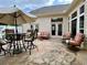 Stone patio with an outdoor dining area, lounge furniture and a market umbrella providing ample shade at 9602 Coastal Pointe Dr, Villa Rica, GA 30180