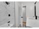Beautiful bathroom featuring a marble tile shower with a rainfall showerhead and modern fixtures at 1891 Sahara Se Dr, Atlanta, GA 30316