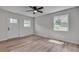 Bright bedroom features new hardwood flooring, a ceiling fan, and double windows at 1891 Sahara Se Dr, Atlanta, GA 30316