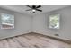 Well-lit bedroom featuring new flooring, two windows, and a modern ceiling fan at 1891 Sahara Se Dr, Atlanta, GA 30316