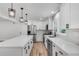 The bright kitchen features stainless steel appliances, a center island, white cabinets and subway tile backsplash at 1891 Sahara Se Dr, Atlanta, GA 30316