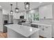 The bright kitchen features new stainless steel appliances, a center island, and white subway tile backsplash at 1891 Sahara Se Dr, Atlanta, GA 30316