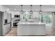 Bright kitchen with white cabinetry, stainless steel appliances, an island, and sliding glass doors to the deck at 1891 Sahara Se Dr, Atlanta, GA 30316