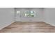 Living room featuring new hardwood flooring, a white door, and double windows at 1891 Sahara Se Dr, Atlanta, GA 30316
