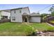 Large backyard with well-kept lawn, patio with string lights, and mature landscaping, perfect for outdoor enjoyment at 2023 Yellow Finch Trl, Atlanta, GA 30316