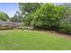 Large backyard with a well-manicured lawn and a stone fire pit sitting area at 2023 Yellow Finch Trl, Atlanta, GA 30316