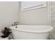 Freestanding tub in bathroom with modern fixtures and adjacent walk in shower at 2023 Yellow Finch Trl, Atlanta, GA 30316