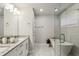 Bathroom with double vanity, soaking tub, glass shower, and granite countertops at 2023 Yellow Finch Trl, Atlanta, GA 30316