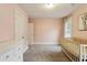 Cozy bedroom with ample natural light, white dresser, plush carpet, and crib, perfect for relaxation at 2023 Yellow Finch Trl, Atlanta, GA 30316