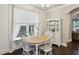Bright dining area with a wood table, white chairs, and view of the backyard at 2023 Yellow Finch Trl, Atlanta, GA 30316