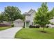 Charming two-story home with well-manicured lawn, mature landscaping, and a welcoming front entrance with a green door at 2023 Yellow Finch Trl, Atlanta, GA 30316