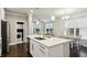 Kitchen with stainless steel appliances, island with sink, breakfast table, and hardwood floors at 2023 Yellow Finch Trl, Atlanta, GA 30316