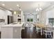 Open floor plan with a kitchen featuring white cabinets, stainless steel appliances, and hardwood floors at 2023 Yellow Finch Trl, Atlanta, GA 30316