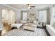 Spacious living room featuring a cozy sectional, decorative rug, and lots of natural light at 2023 Yellow Finch Trl, Atlanta, GA 30316