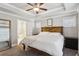 Comfortable main bedroom with tray ceiling, ceiling fan, and access to bathroom at 2023 Yellow Finch Trl, Atlanta, GA 30316