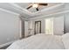 Spacious main bedroom with tray ceiling, ceiling fan, and ensuite bath at 2023 Yellow Finch Trl, Atlanta, GA 30316
