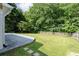Large backyard with a well-maintained lawn, mature trees, and a wooden fence at 3362 Palm Nw Cir, Kennesaw, GA 30144