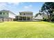 Spacious backyard featuring a large grassy area and covered patio, perfect for outdoor entertaining at 3362 Palm Nw Cir, Kennesaw, GA 30144