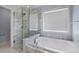 Elegant bathroom featuring a soaking tub and a glass-enclosed shower with marble surround at 3362 Palm Nw Cir, Kennesaw, GA 30144