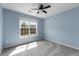 Cozy bedroom featuring blue walls, plush carpeting, and a window offering natural light at 3362 Palm Nw Cir, Kennesaw, GA 30144