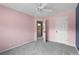 Bright bedroom featuring pink walls, gray carpet and a doorway into the ensuite bathroom at 3362 Palm Nw Cir, Kennesaw, GA 30144