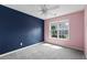 Stylish bedroom with a blue accent wall and a window that brings in natural light at 3362 Palm Nw Cir, Kennesaw, GA 30144