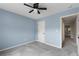 Comfortable bedroom featuring blue walls, carpet flooring, and a door into the hallway at 3362 Palm Nw Cir, Kennesaw, GA 30144