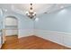 Formal dining room featuring elegant wainscoting, hardwood floors, and a decorative chandelier at 3362 Palm Nw Cir, Kennesaw, GA 30144