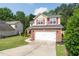 Two-story home with brick accents, red shutters, an American flag, a well-manicured lawn, and an attached two-car garage at 3362 Palm Nw Cir, Kennesaw, GA 30144