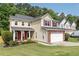 Inviting two-story home with a well-kept lawn, brick-accented garage, red shutters, and lovely curb appeal in a peaceful neighborhood at 3362 Palm Nw Cir, Kennesaw, GA 30144