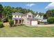 Inviting two-story home with a well-kept lawn, brick-accented garage, red shutters, and lovely curb appeal in a peaceful neighborhood at 3362 Palm Nw Cir, Kennesaw, GA 30144